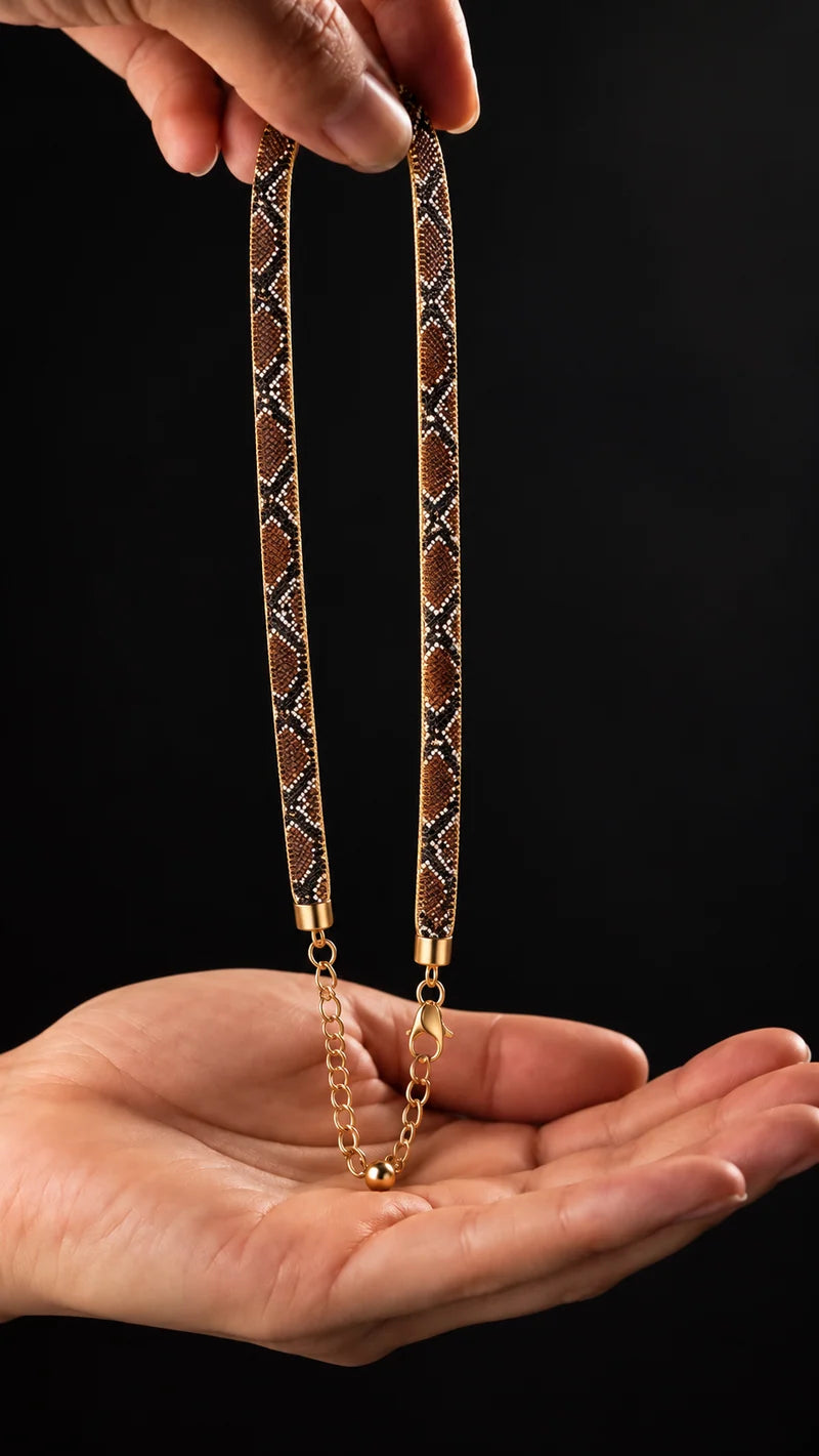 snake-pattern woven necklace held in hand
