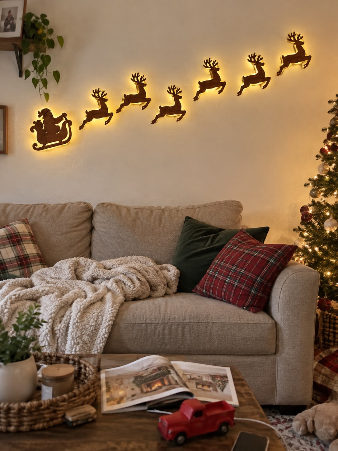 Glowing Santa and reindeer wall display in a living room