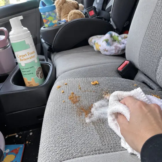 Car seat snack stain cleaned with foam and towel