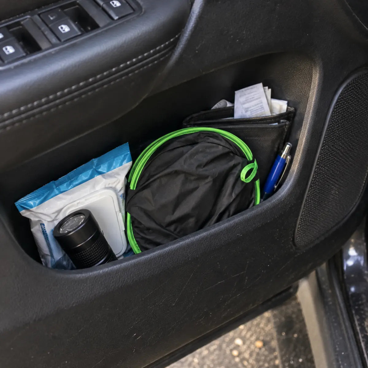 Folded sun shade stored in a car door pocket