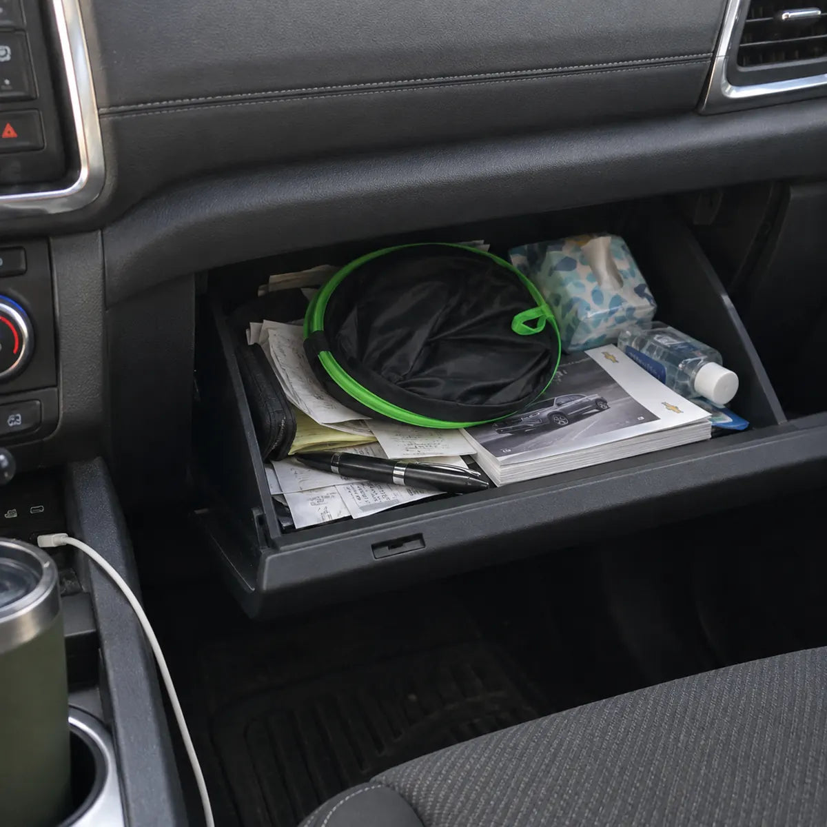 Folded windshield sun shade stored inside a glove box