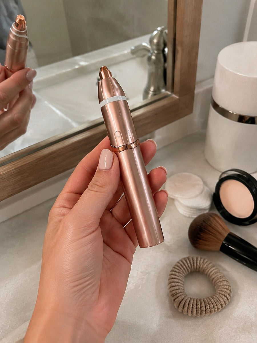 Dluvivo trimmer held beside a mirror before makeup