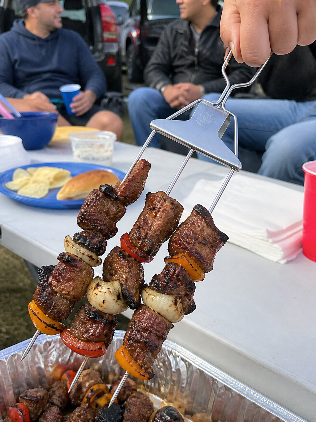 Tailgate food close-up with 3-way grill skewers