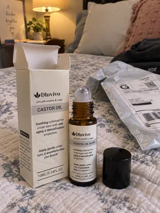 Woman using under-eye roller serum before a video meeting