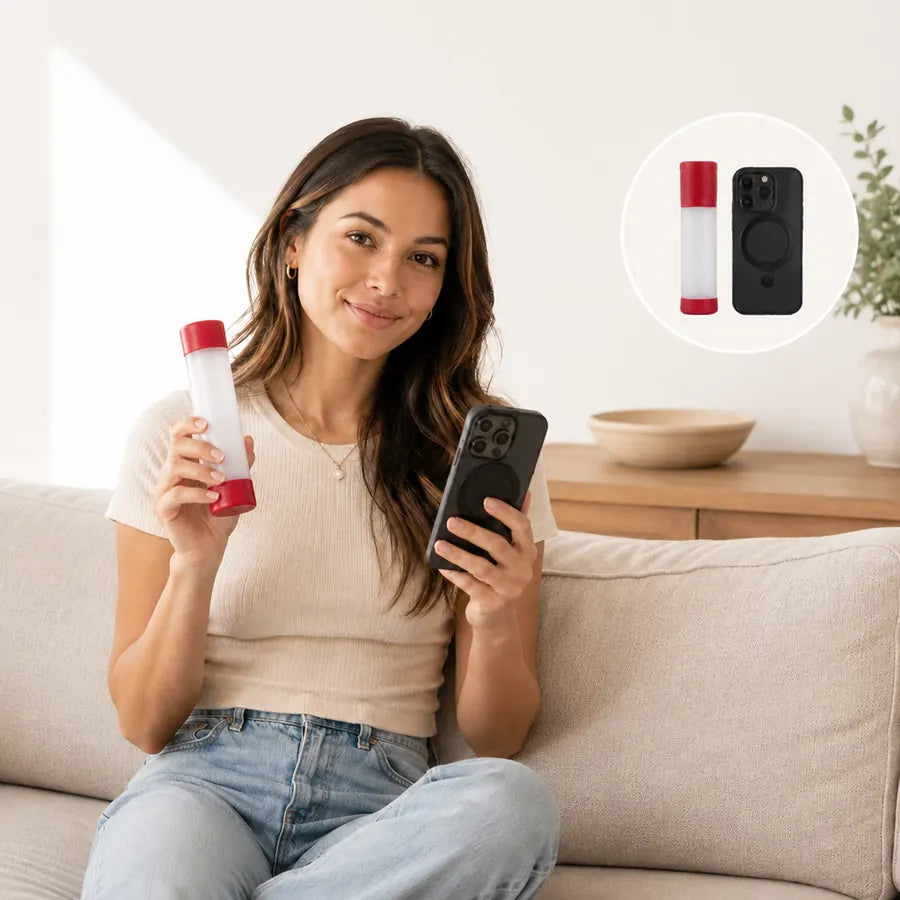 Woman holding compact choking relief device beside a smartphone