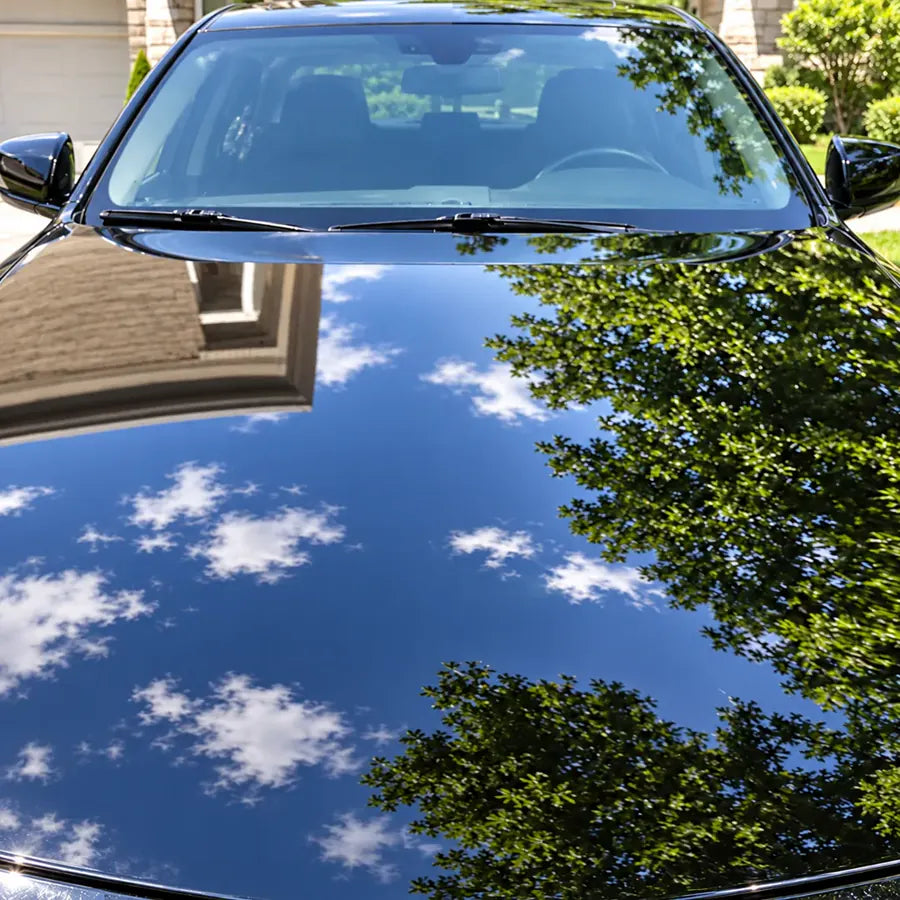 Our treated car surface with water beads rolling off glossy paint