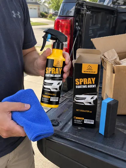 Customer holding car coating spray beside a truck tailgate