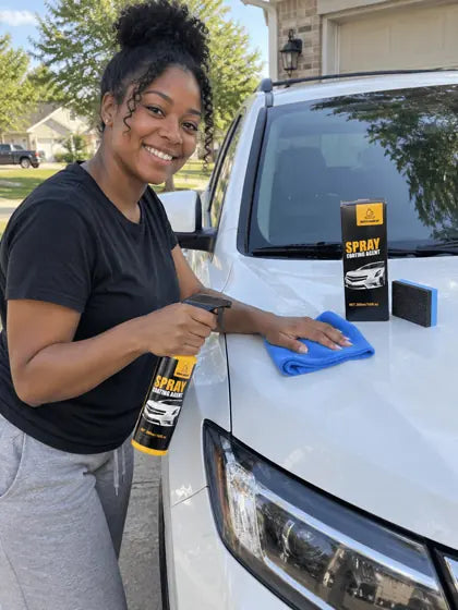 Customer wiping a white car hood with car coating spray