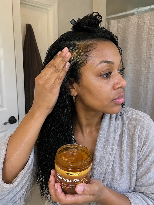 Customer holding NAVOZILO Batana Oil with styled edges