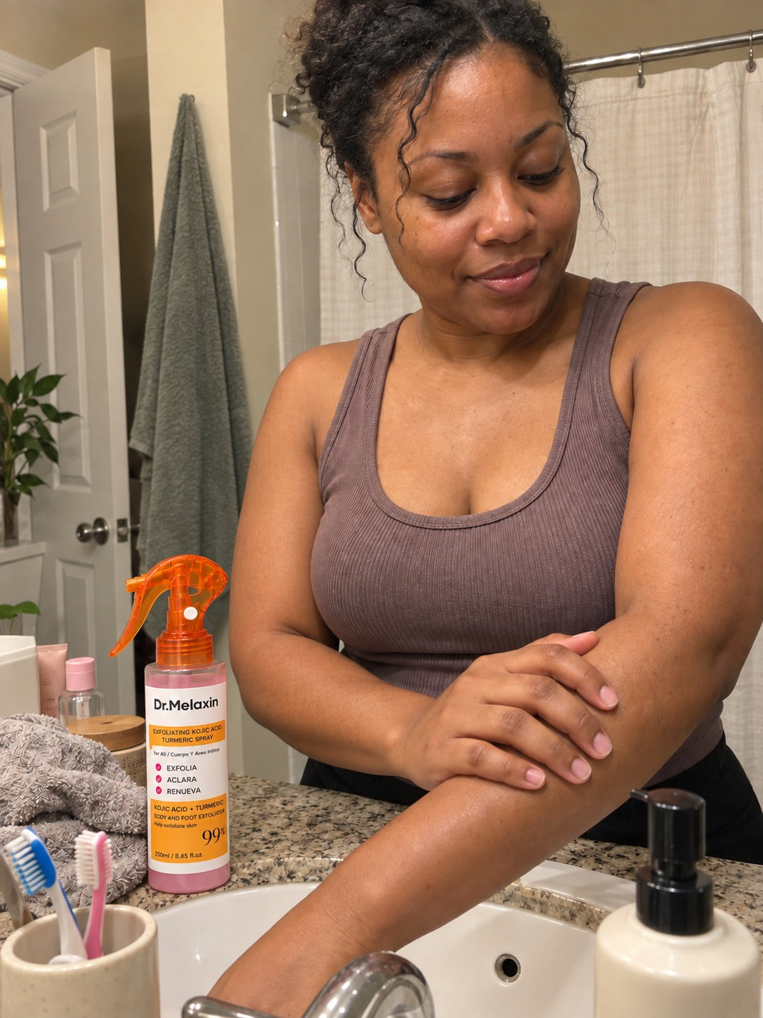 Customer adding a spray exfoliant to a gentle body-care routine