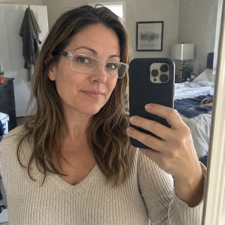 Customer wearing clear frame glasses in a mirror selfie