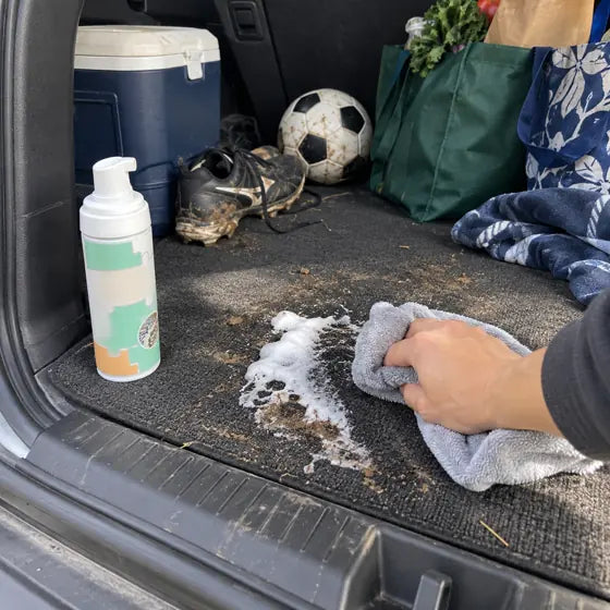 Car trunk mat cleaned with foam stain remover