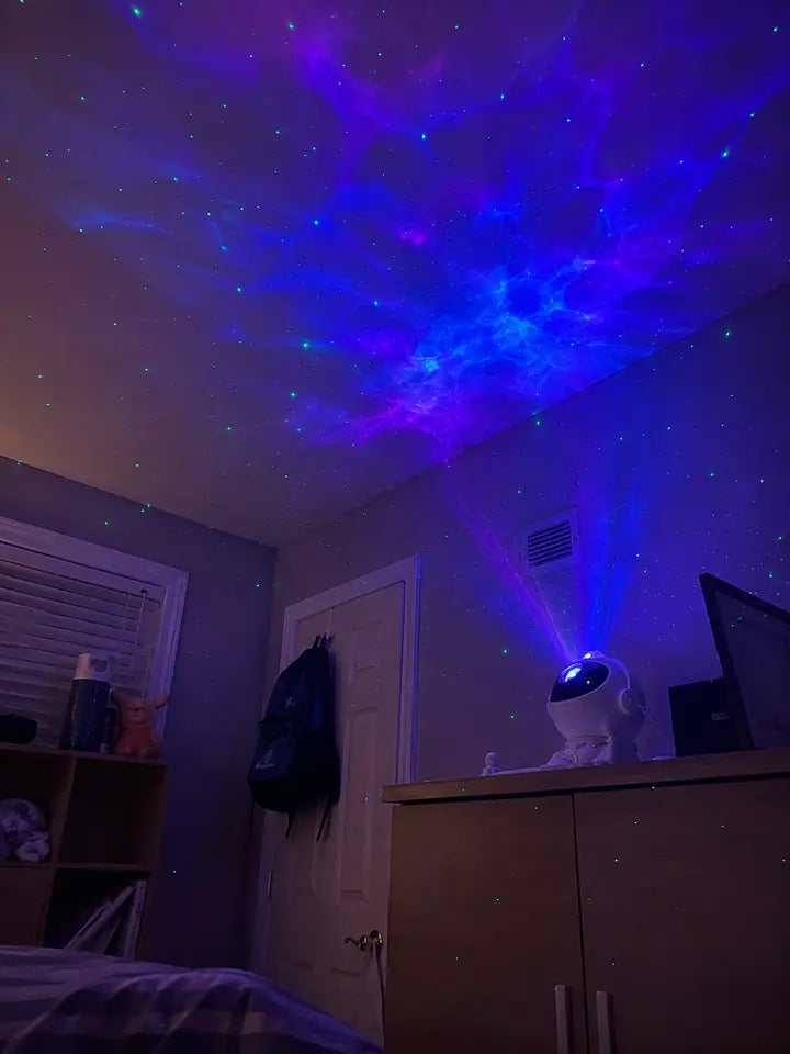 Galaxy star projector casting blue and purple nebula lights across a ceiling