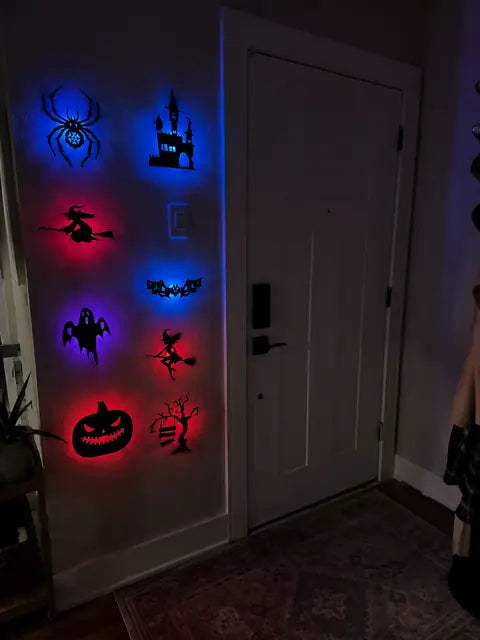 Customer front door wall decorated with glowing Halloween silhouette lights