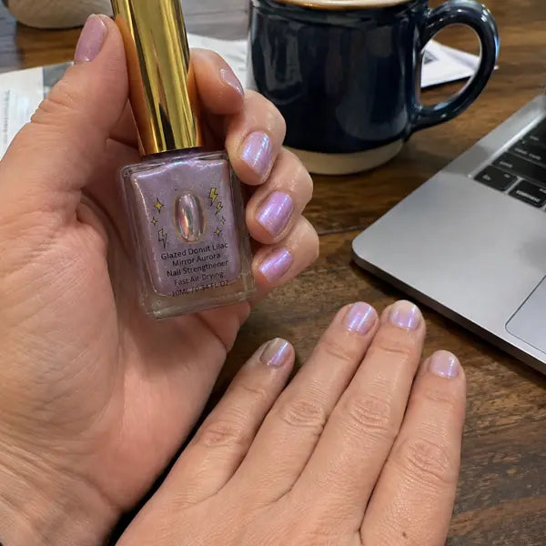 Customer showing lilac manicure at a work desk