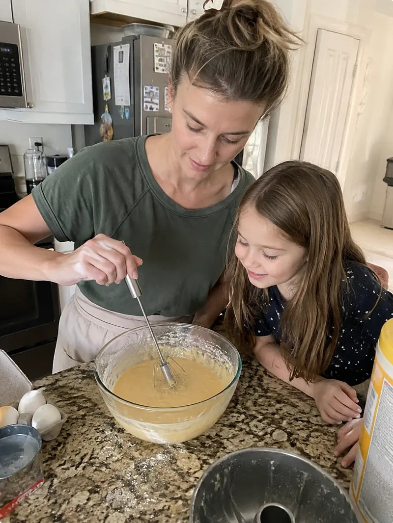 Family baking together with the hand-push rotary whisk and batter bowl