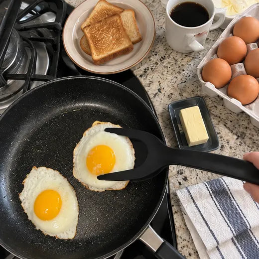 Grip and flip spatula tongs lifting a fried egg