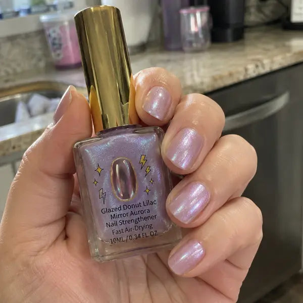 Customer holding lilac nail strengthener in a kitchen