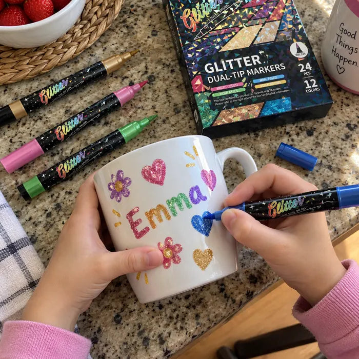 Child decorating a ceramic mug with glitter markers