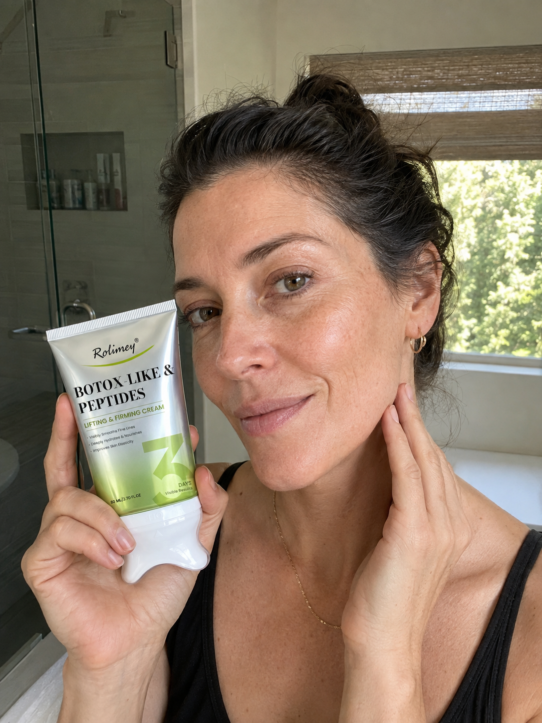Customer holding Rolimey cream near face