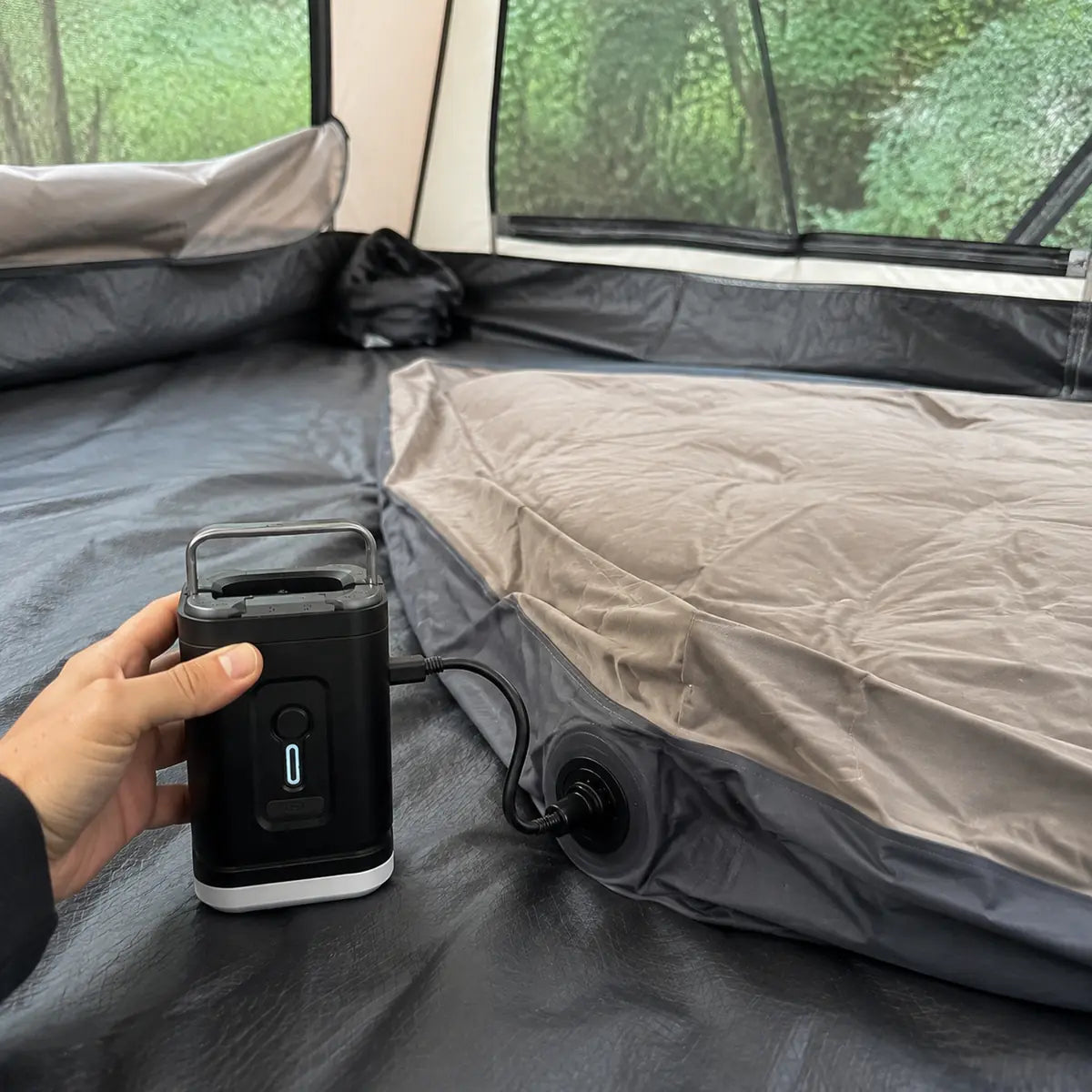 Lisa C. customer photo: air pump inflating a camping air mattress inside a tent