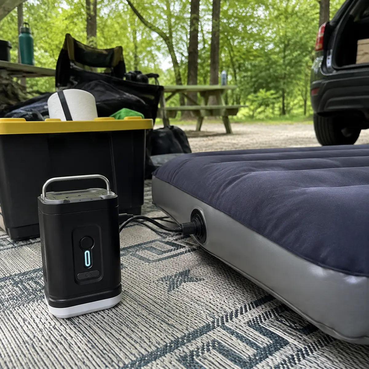 Marcus T. customer photo: air pump connected to an air mattress during campsite pack-down