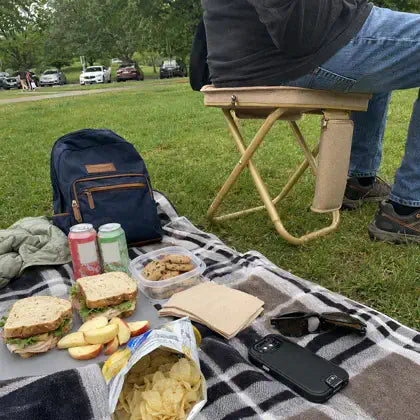 Compact folding stool at a park picnic