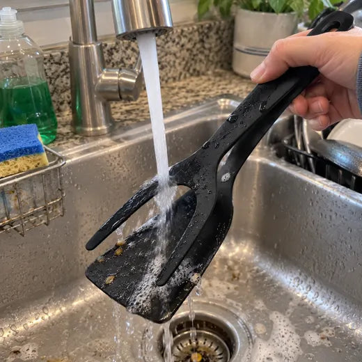 Grip and flip spatula tongs being rinsed under a faucet