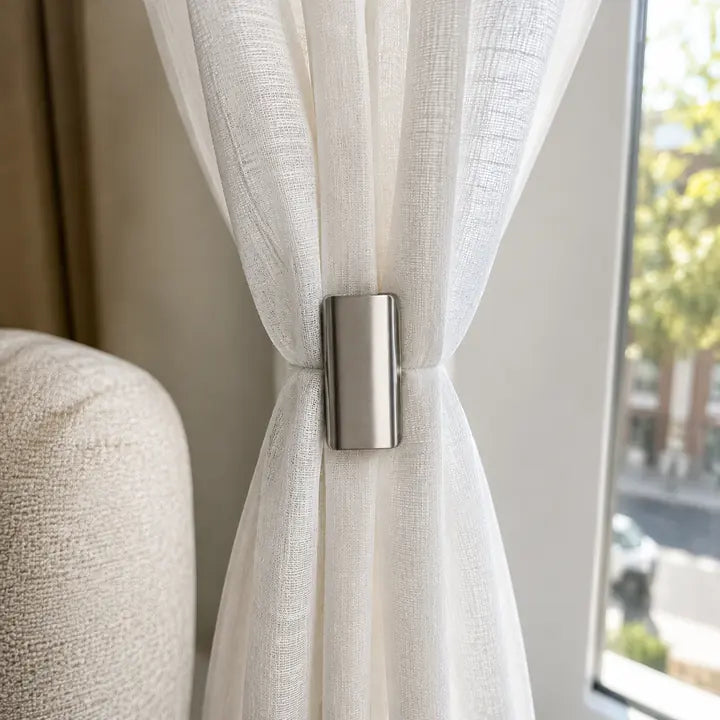 Sheer curtain fabric held with magnetic clip