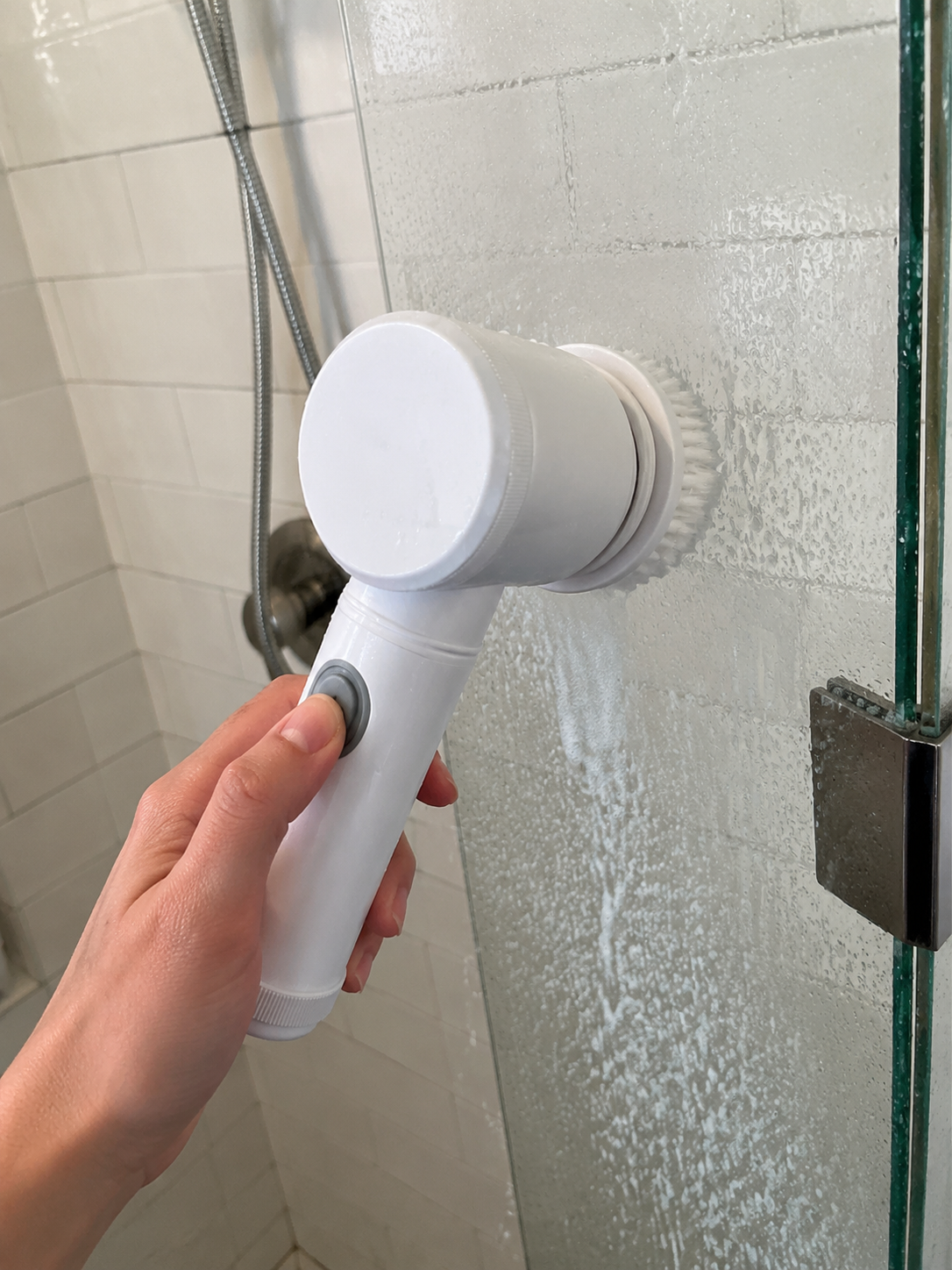 Customer photo of electric spin scrubber cleaning shower glass.