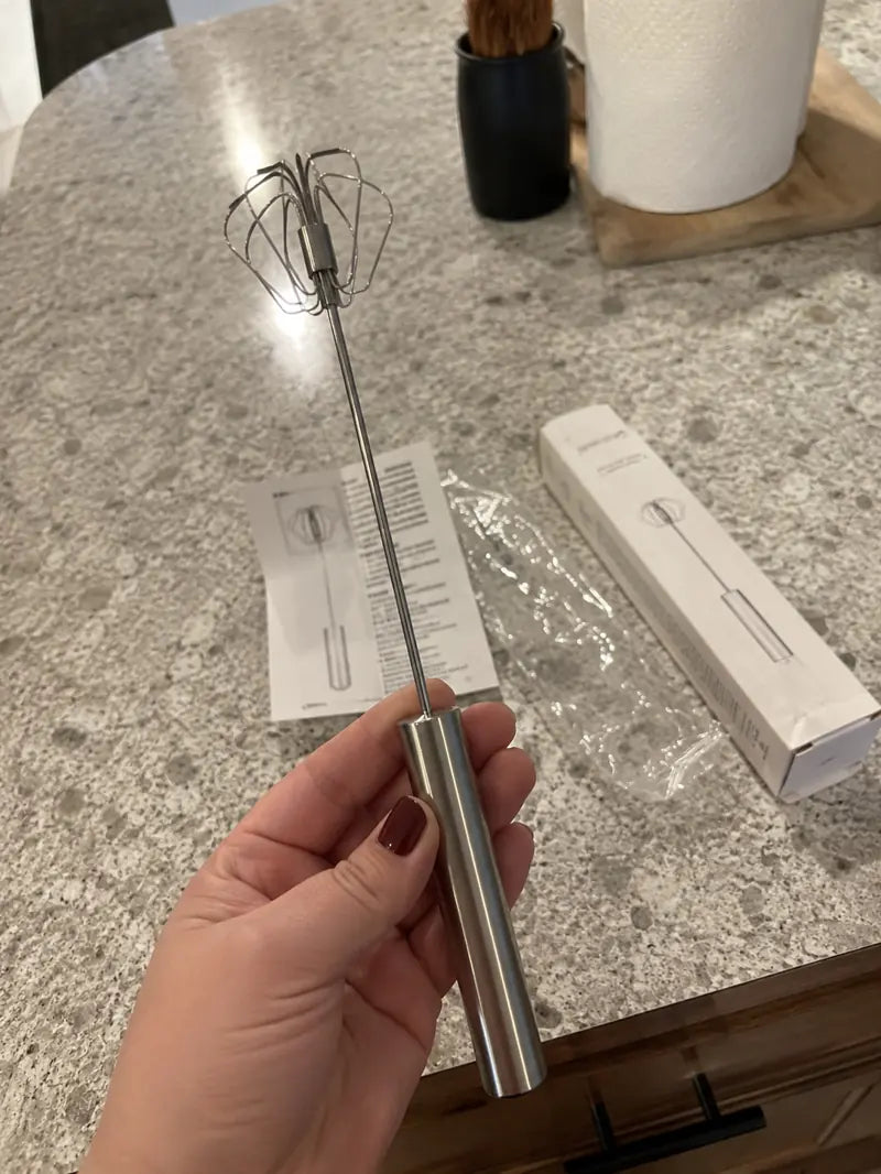 Customer holding the stainless steel rotary whisk after opening the package