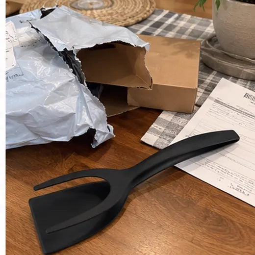 Grip and flip spatula tongs unboxed on a table