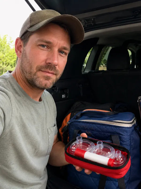 Brian Cole storing the emergency choking relief kit in a vehicle