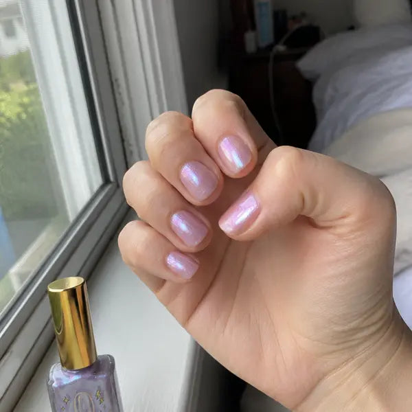Customer showing lilac glossy nails by a window