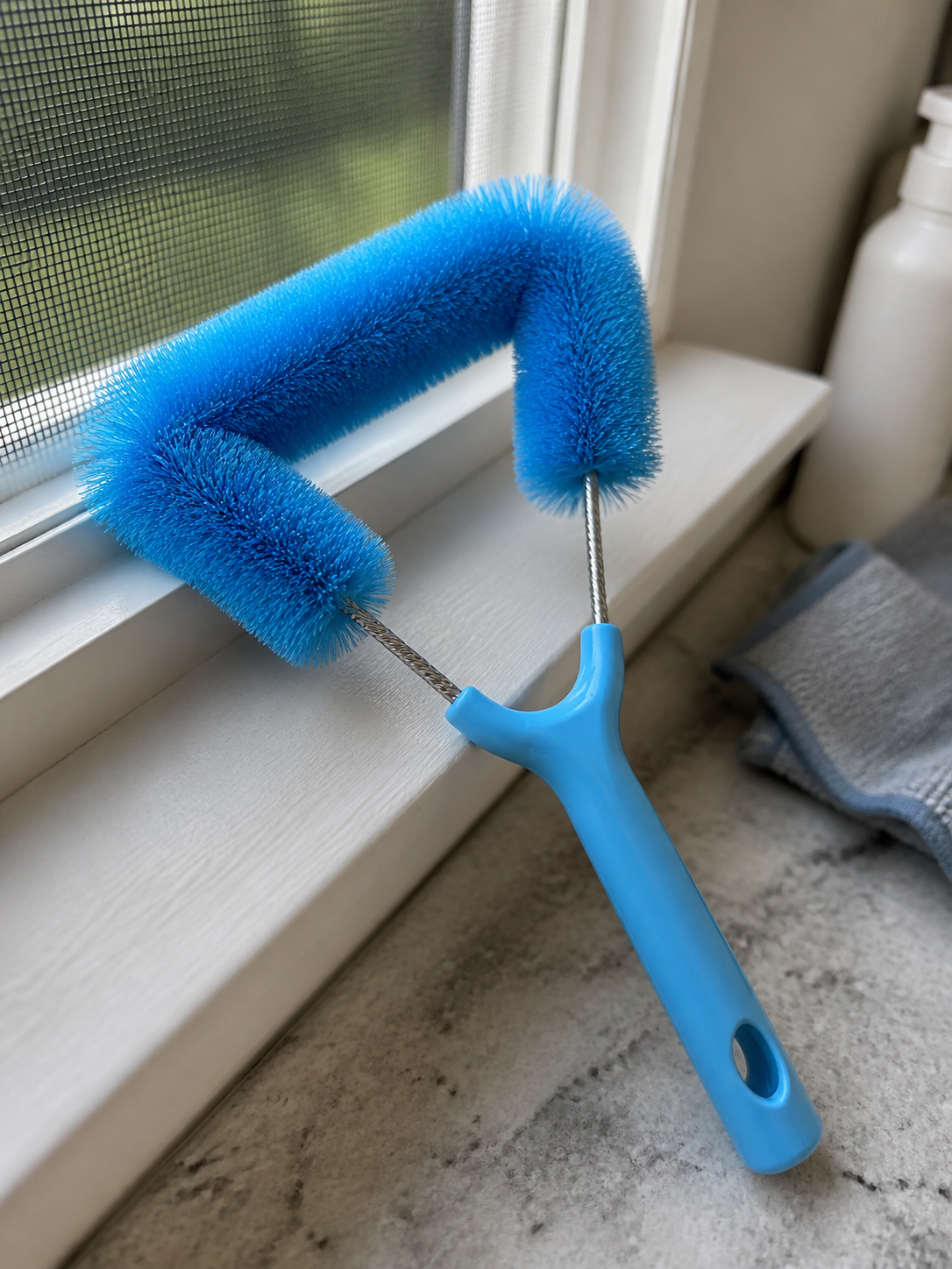 Customer photo of blue screen brush detail on a windowsill.