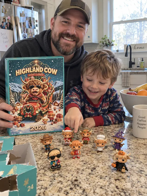 Dad and son arranging Highland Cow countdown figures on a kitchen counter